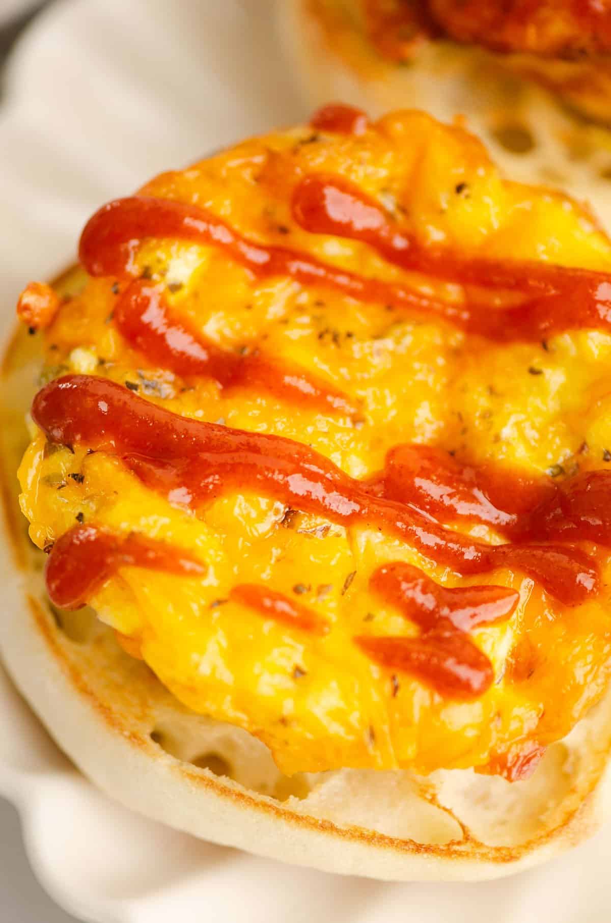 protein egg bite topped with drizzle of sriracha