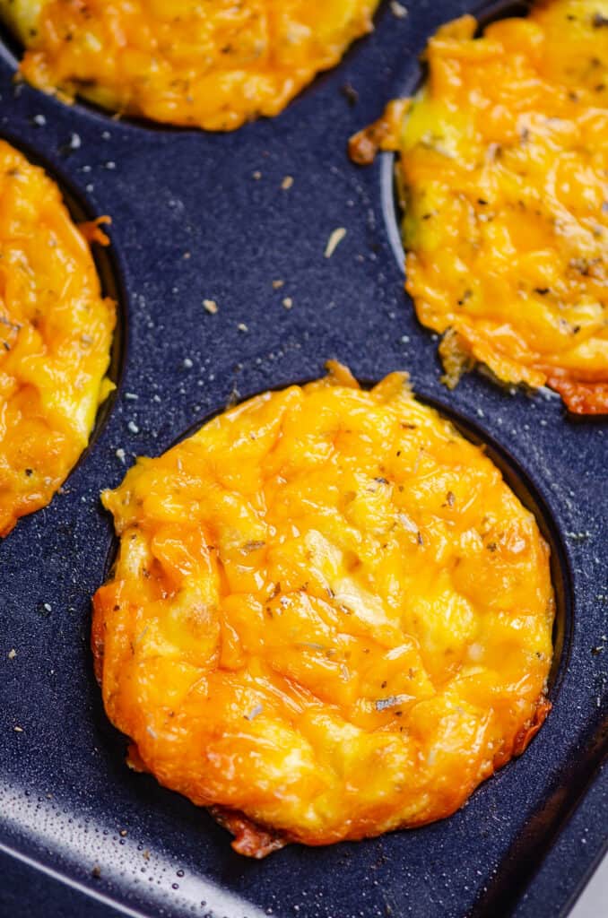 cheesy ham egg bites in muffin tin