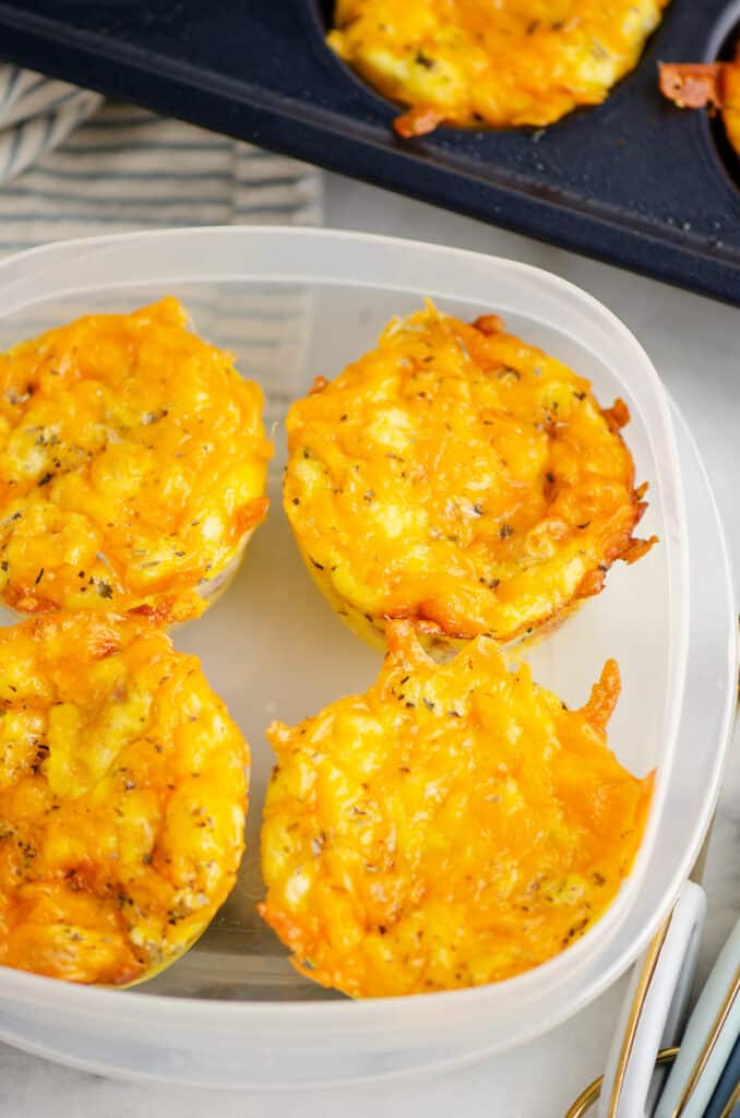 cheesy ham and egg bites in Tupperware container