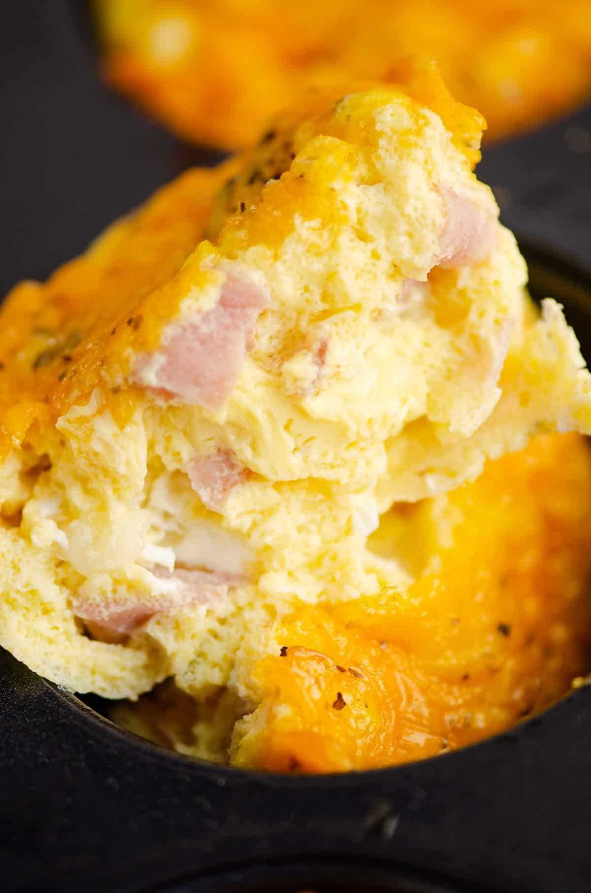 half of fluffy cheesy ham and egg cup on pan
