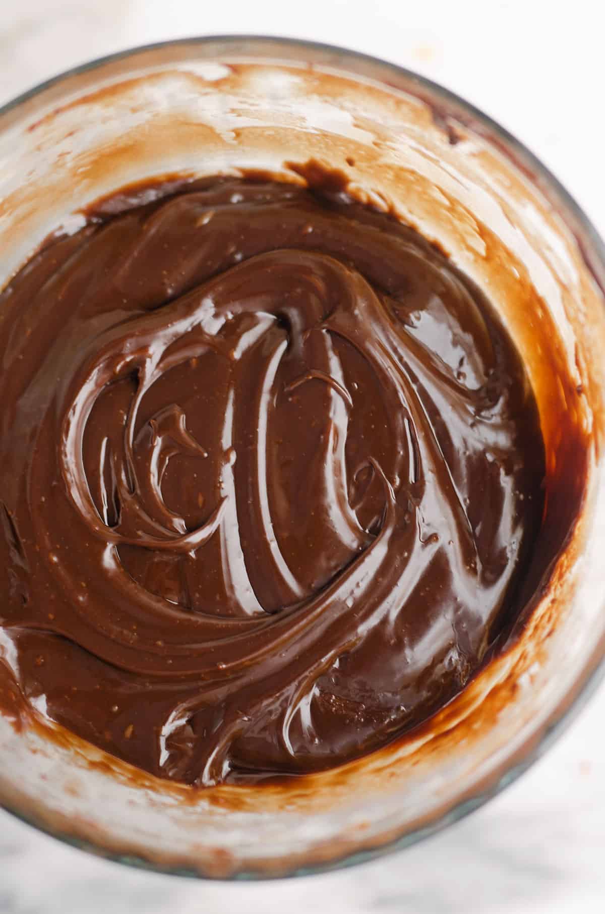 shiny chocolate ganache in glass bowl