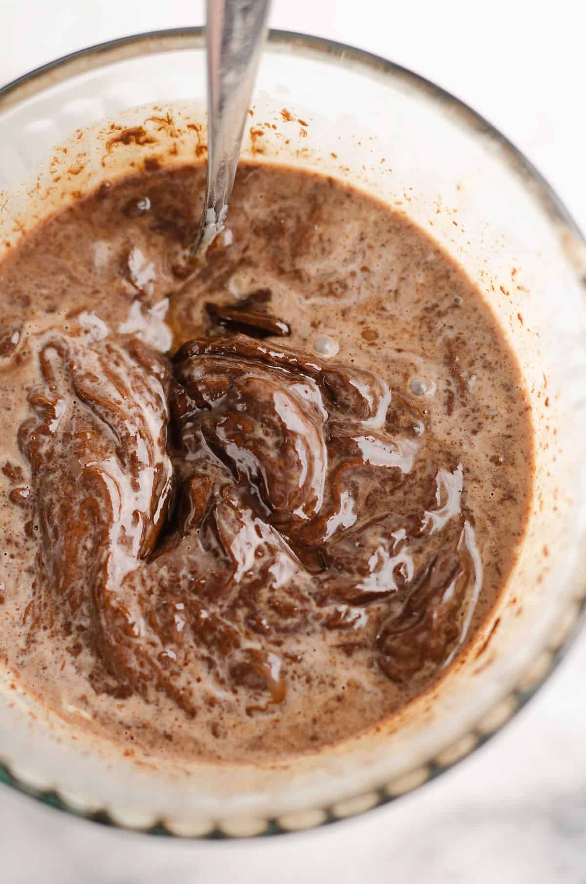 chocolate and cream mixed together in glass bowl