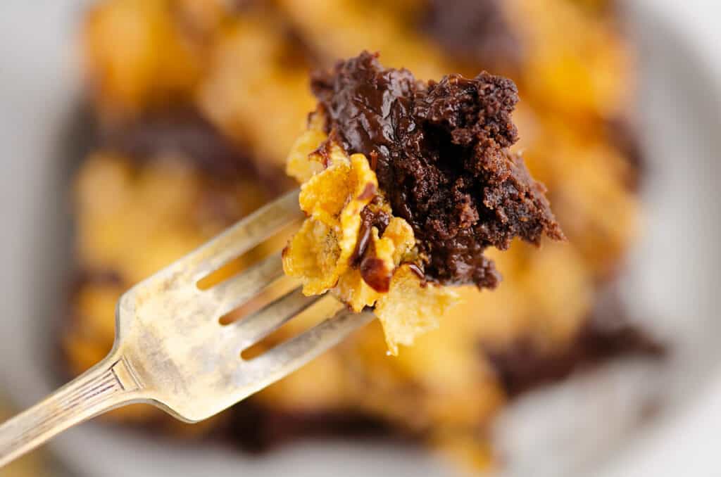 bite to layered cornflake brownie on fork