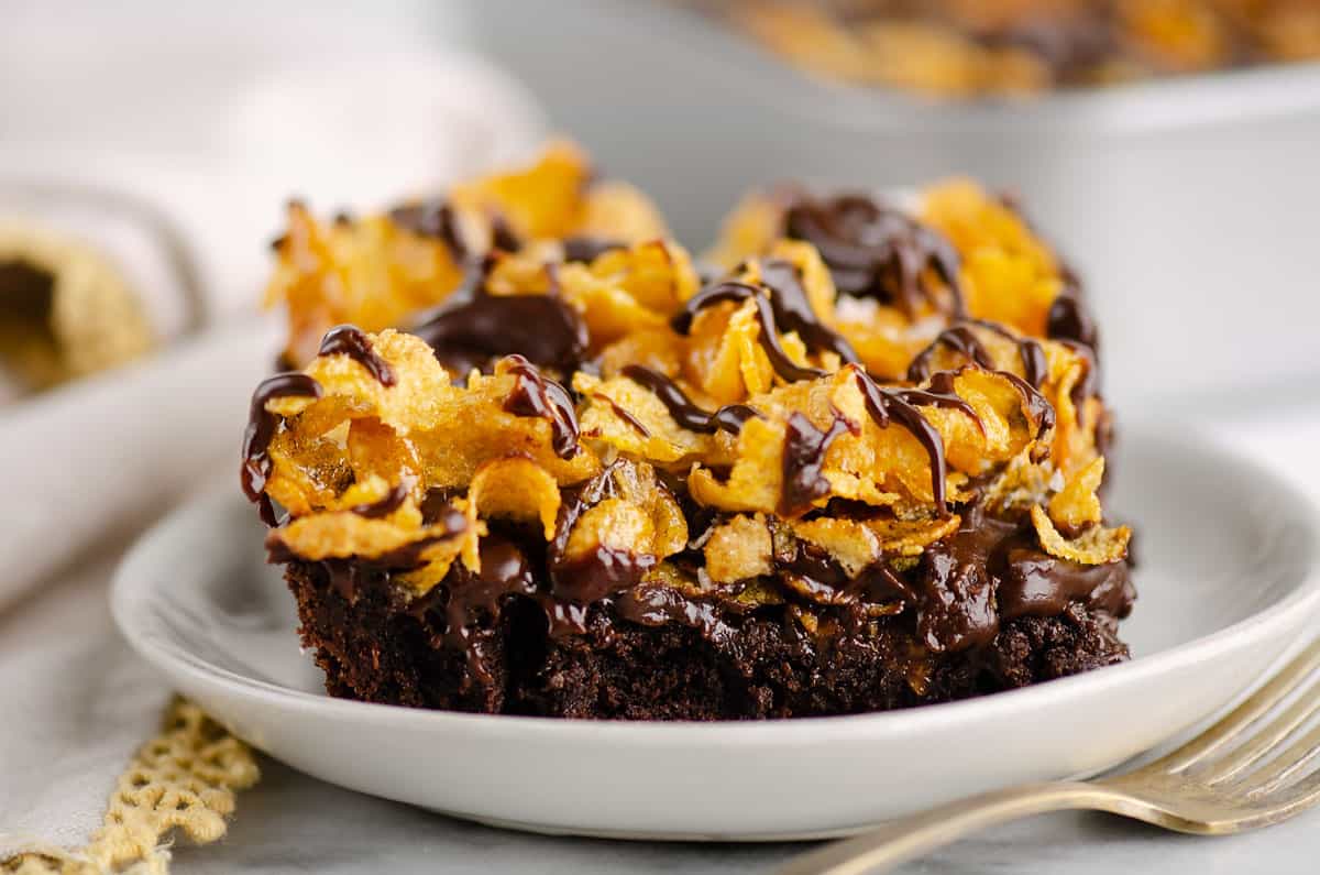 ganache and cornflake layered brownie on white plate