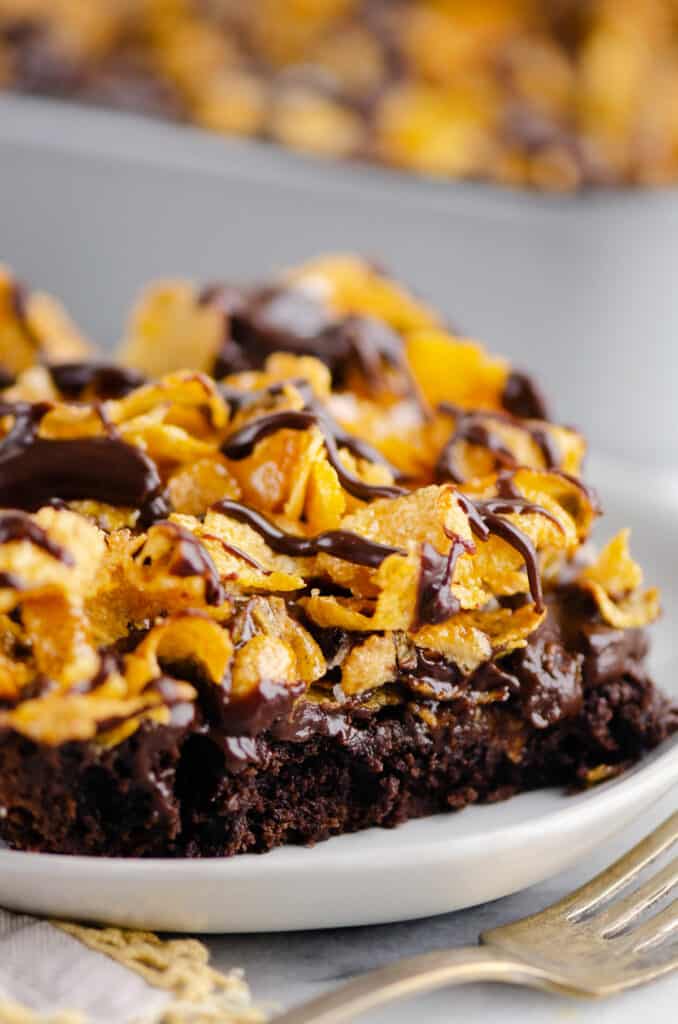 triple layered brownies with cornflakes on plate with napkin