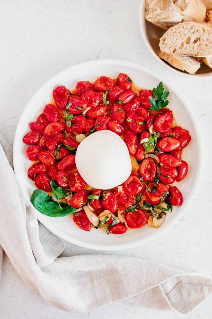roasted tomatoes and mozzarella with basil on plate