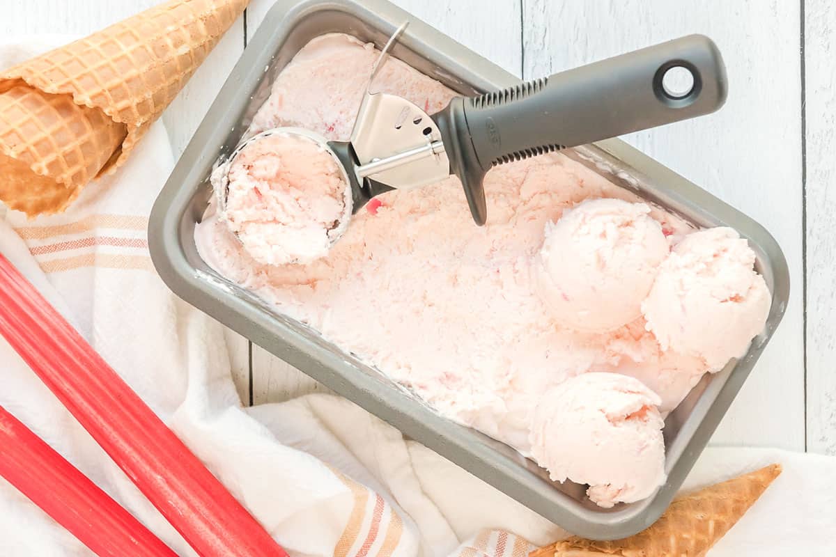 rhubarb ice cream in loaf pan with scoop