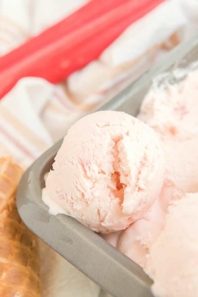 round scoop of rhubarb ice cream in loaf pan