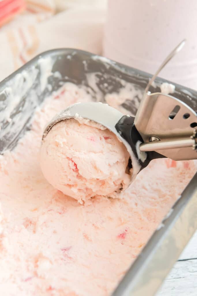 no churn rhubarb ice cream in loaf pan scooped with ice cream scoop