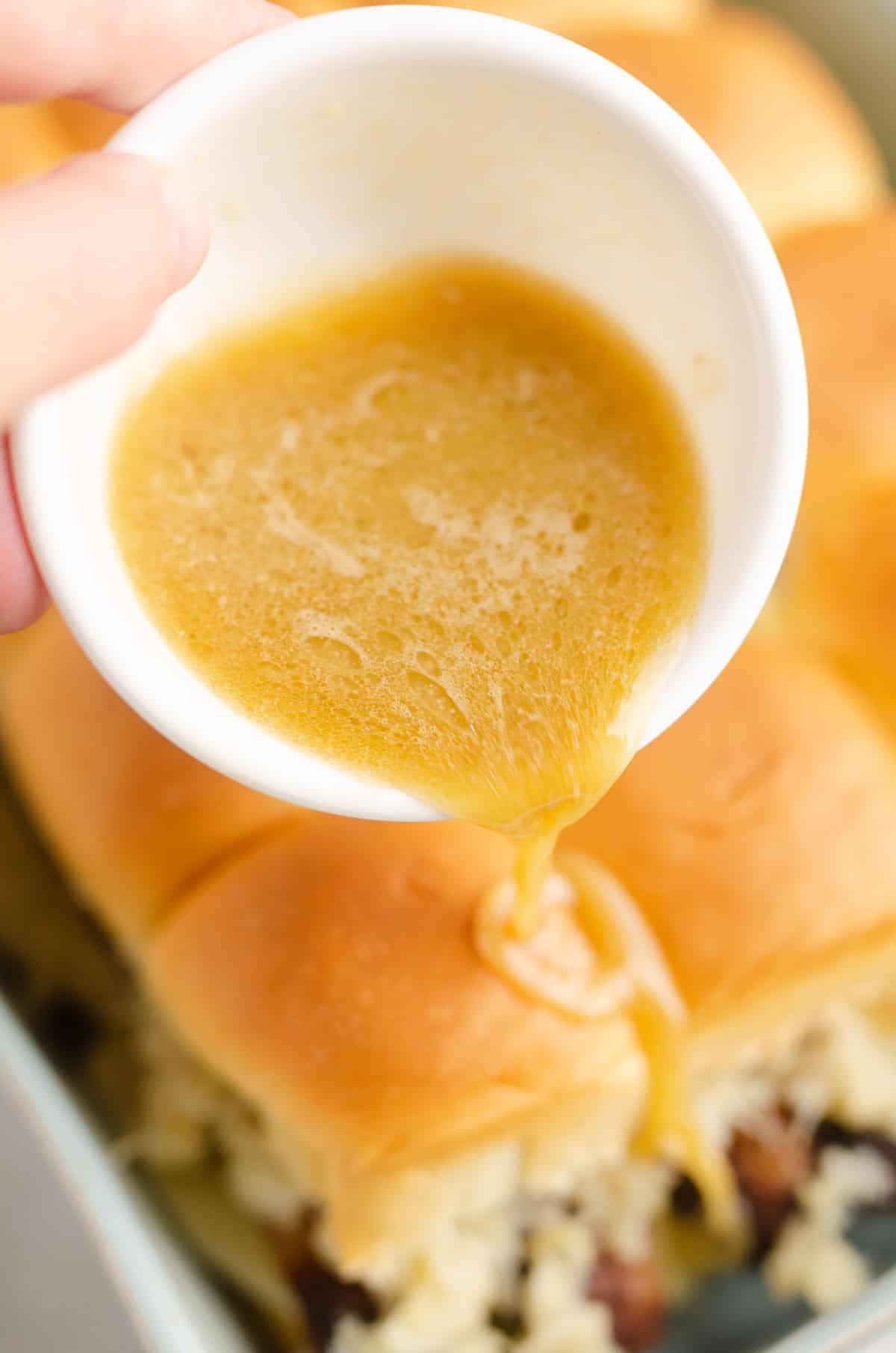 butter sauce poured over sliders