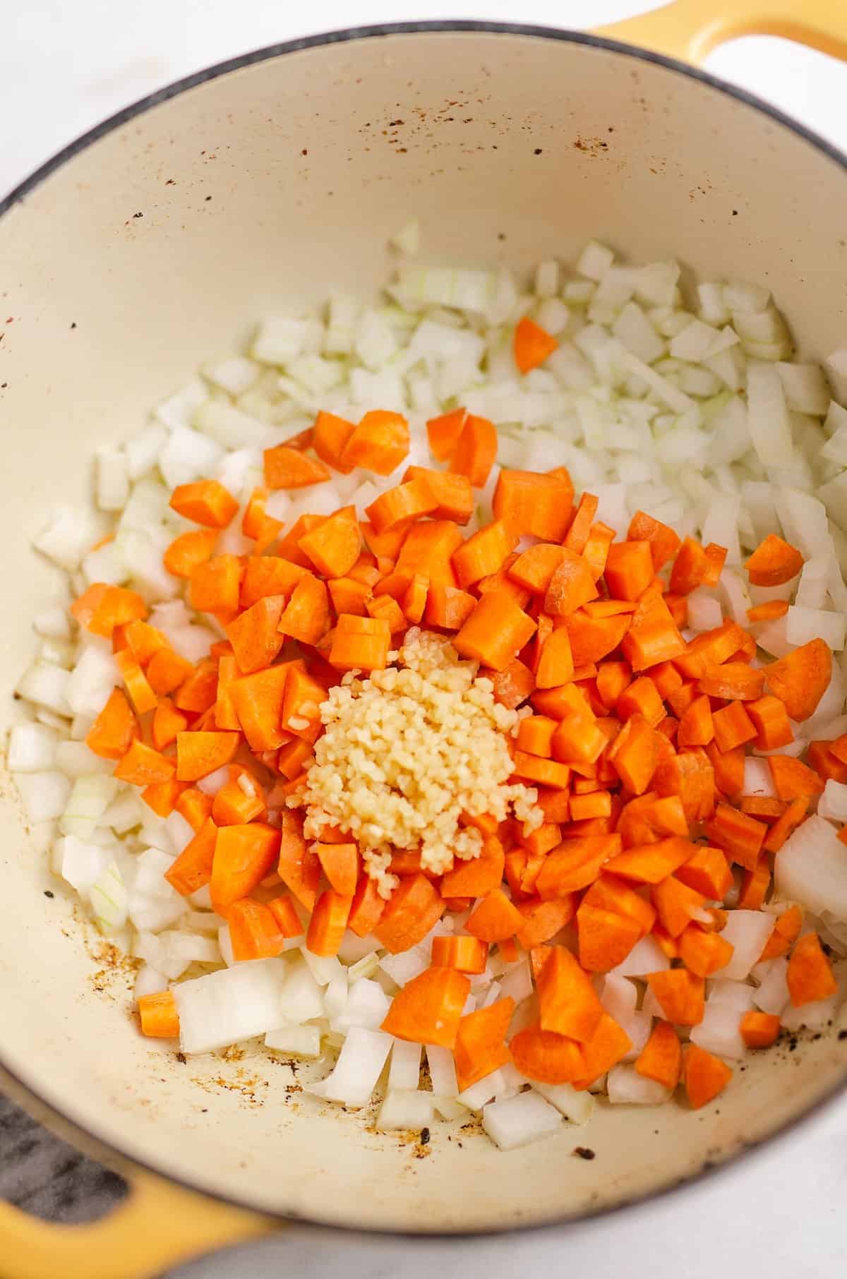 carrots garlic and onions in yellow pot