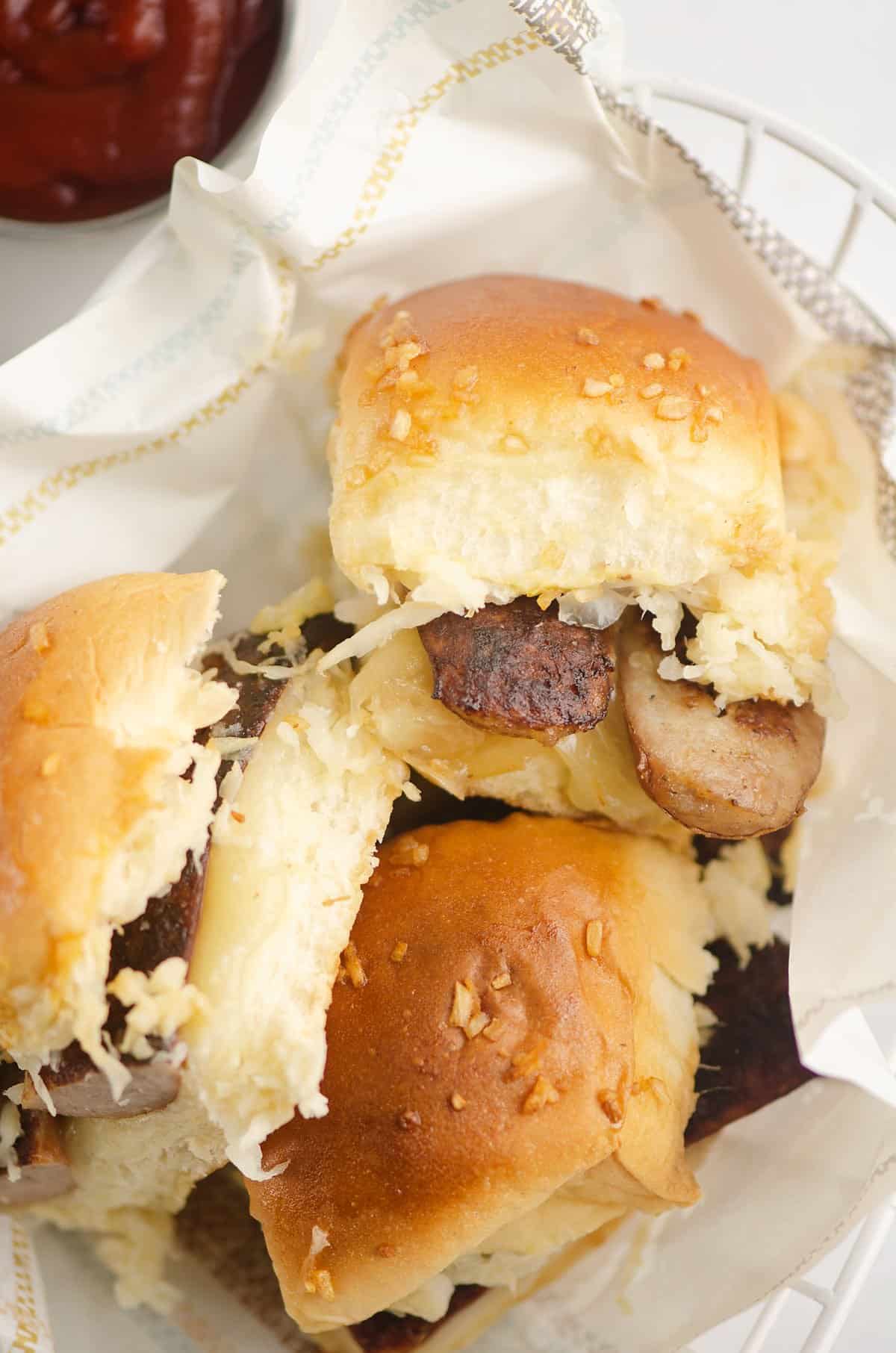 sauerkraut brat sliders in tissue lined basket