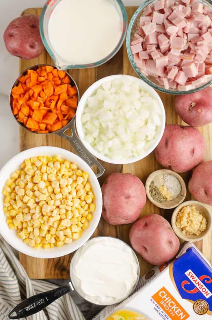 creamy ham and potato soup ingredients on cutting board