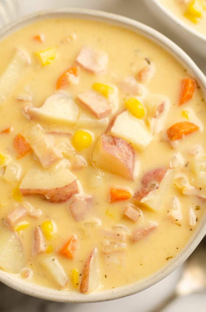 white bowl of creamy ham and potato soup