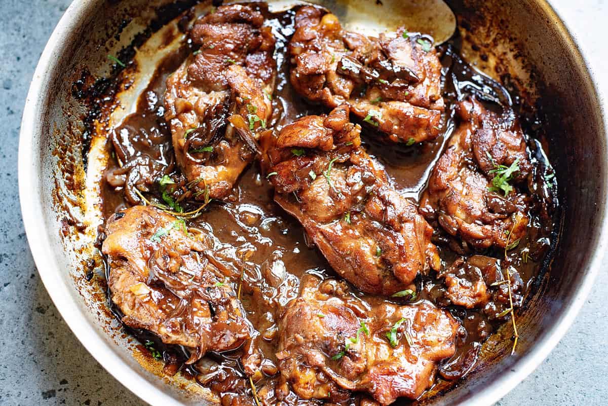 pan with honey beer chicken thighs topped with cilantro