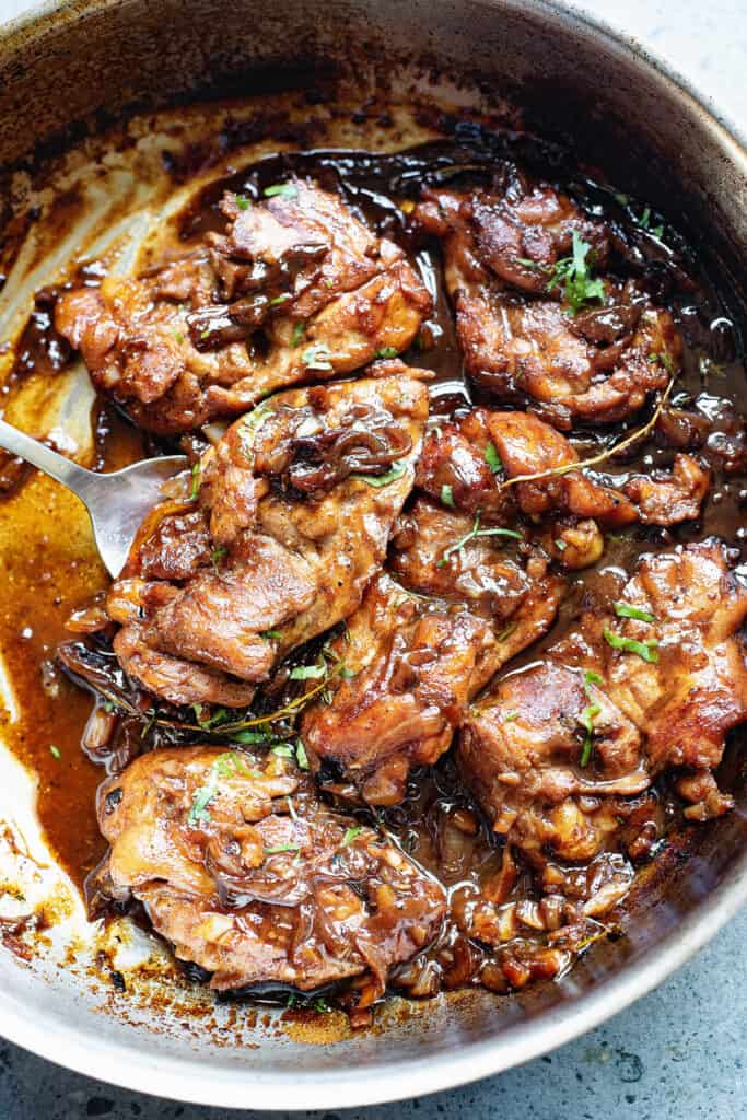 honey beer chicken thighs in pan with sauce reduction