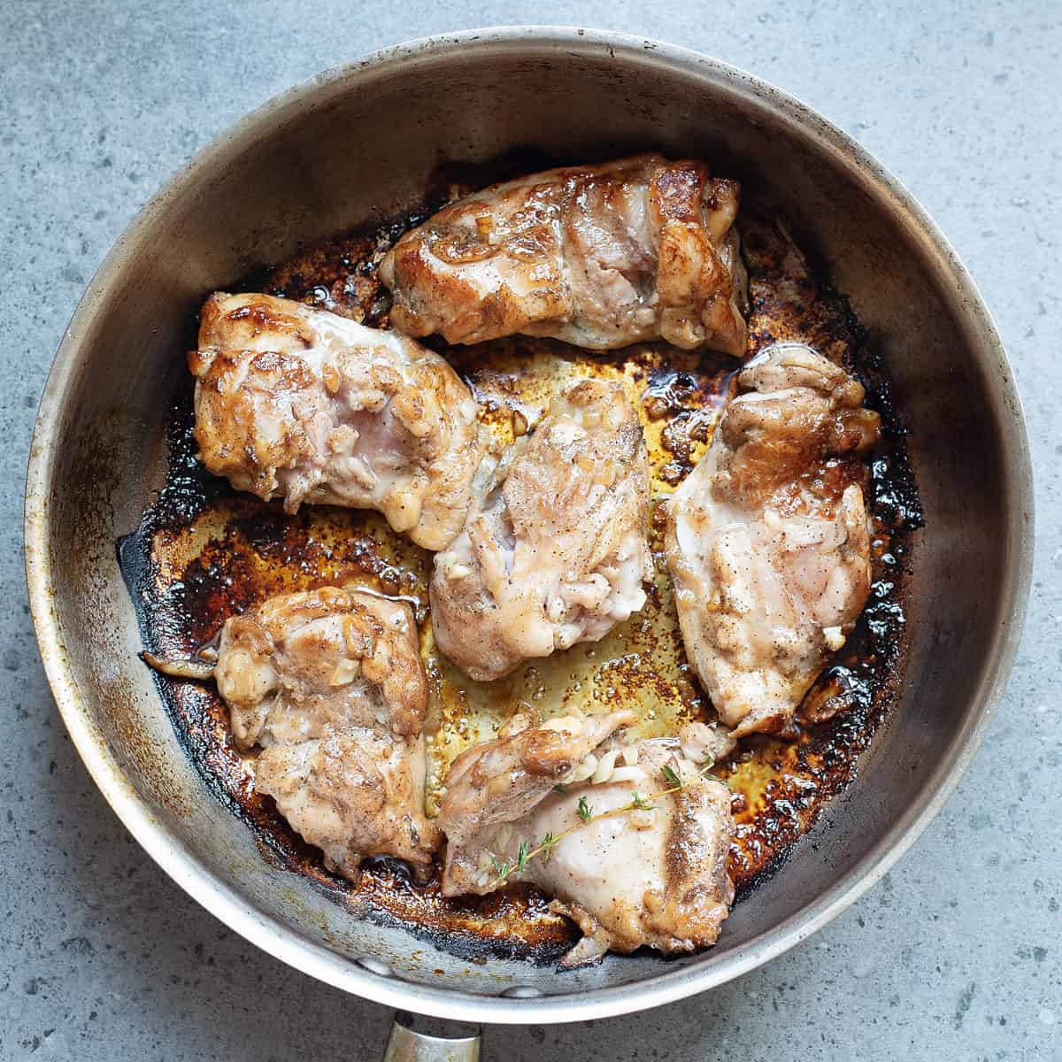 chicken thighs seared in pan