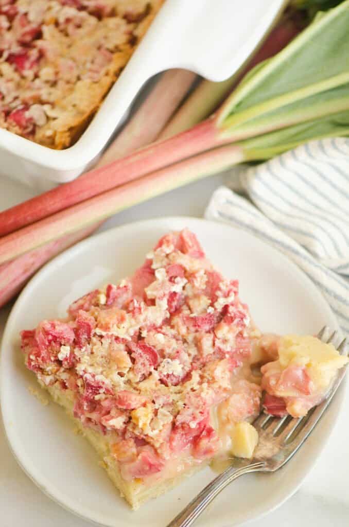 rhubarb dream bar on plate with bite on fork