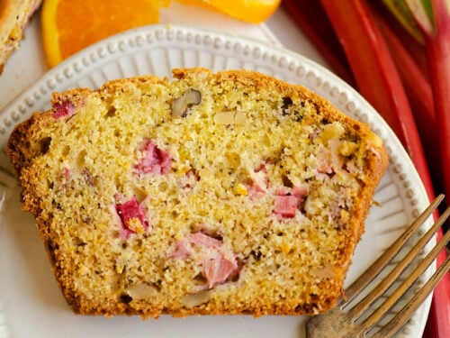 slice of rhubarb walnut orange bread with fork on plate