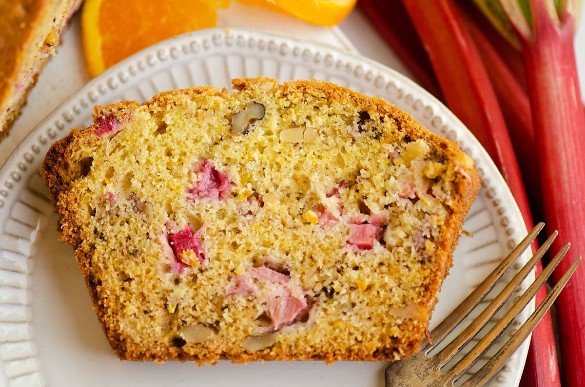slice of rhubarb walnut orange bread with fork on plate