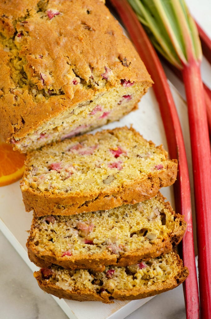 sliced rhubarb walnut orange bread on cutting board