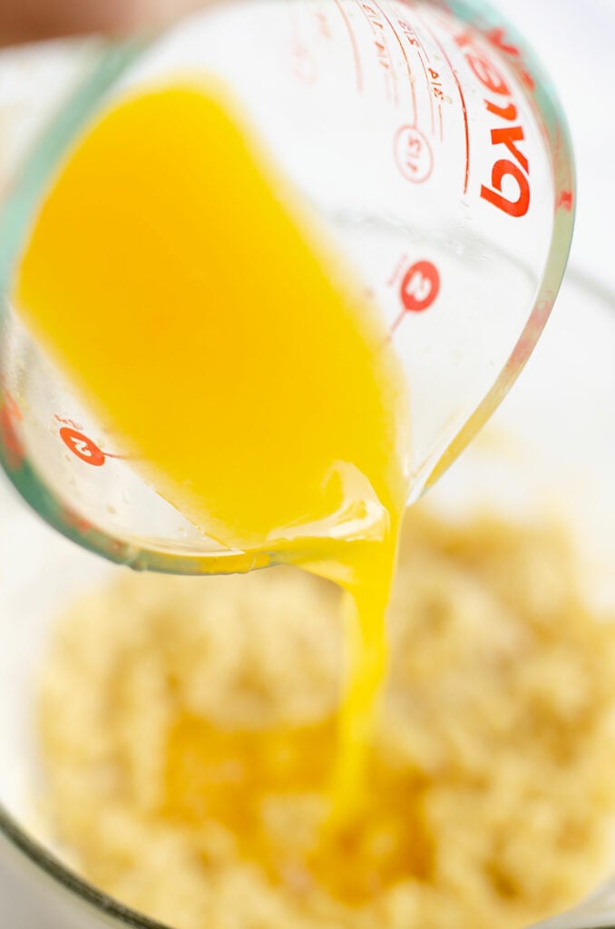 fresh orange juice poured into batter
