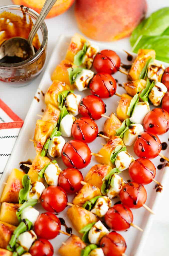 mini skewers with peaches, cherry tomatoes, basil and cheese