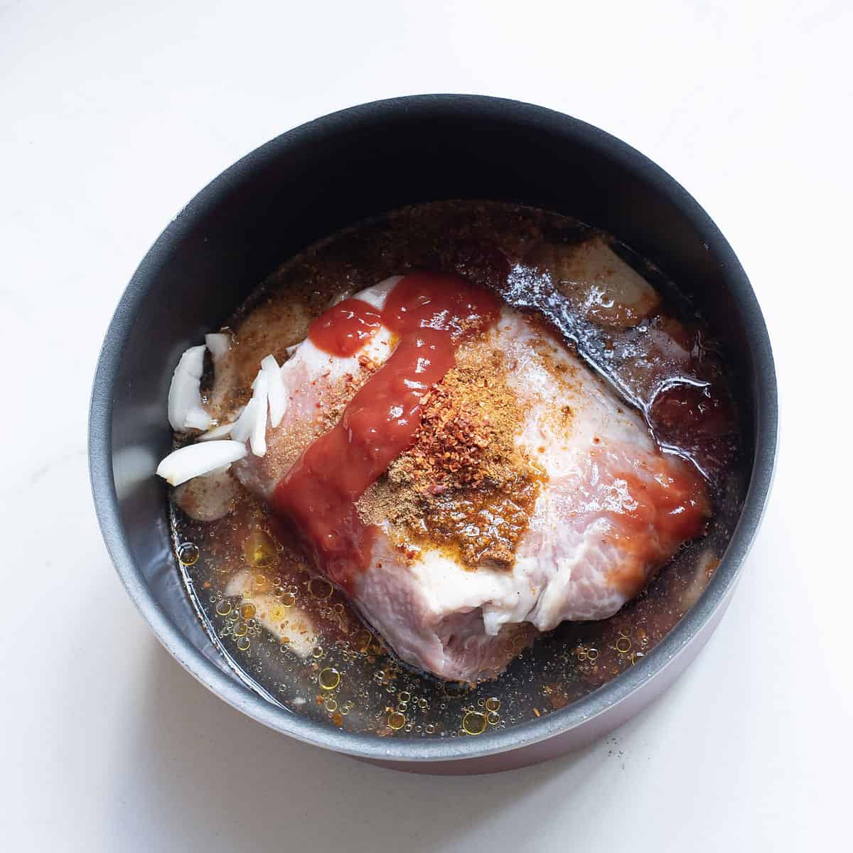 pork butt in pot with spices and salsa