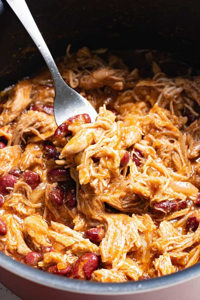 fork in pot of pulled pork and beans