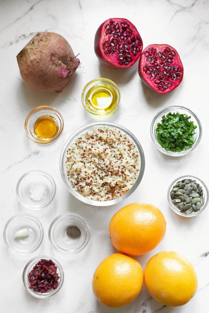 ingredients for Beet & Orange Quinoa Salad on white marble