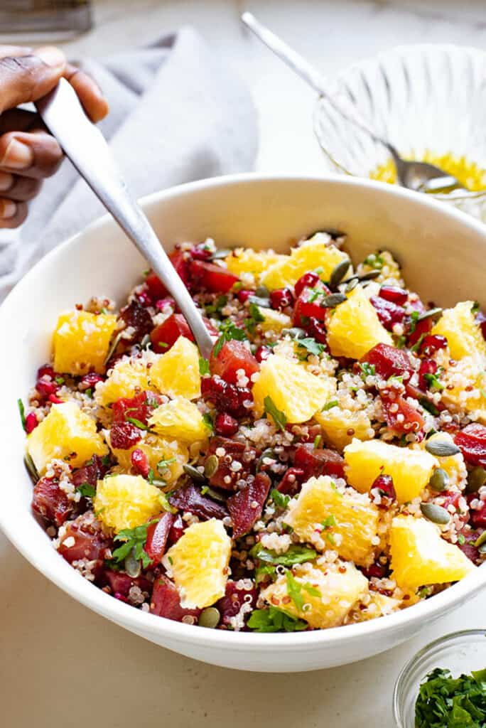 spoon in bowl of Beet & Orange Quinoa Salad