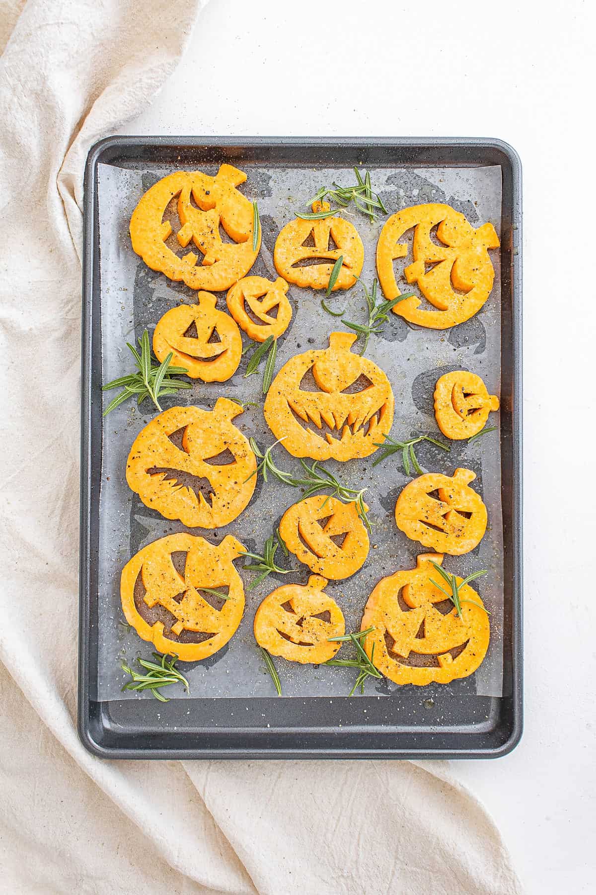 jack o lantern sweet potato shapes on baking sheet