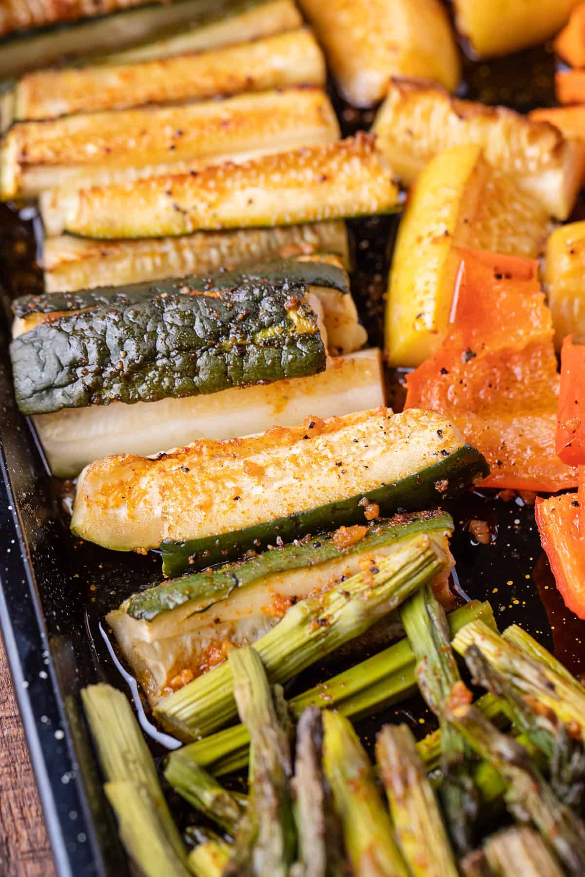 seasoned and smoked zucchini on pan of vegetables