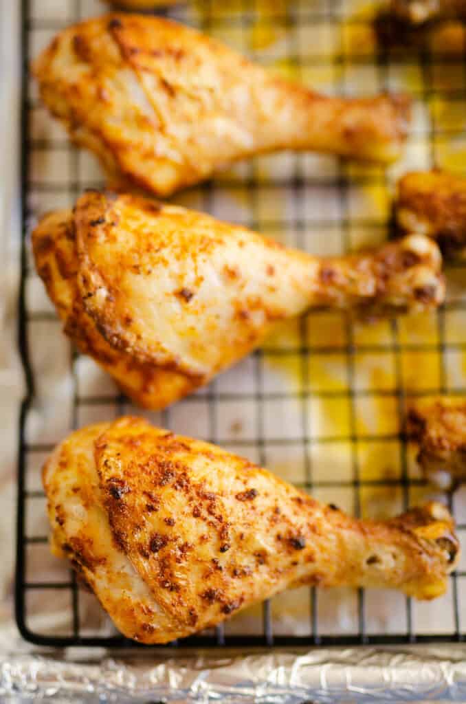 baked chicken legs on cooling rack