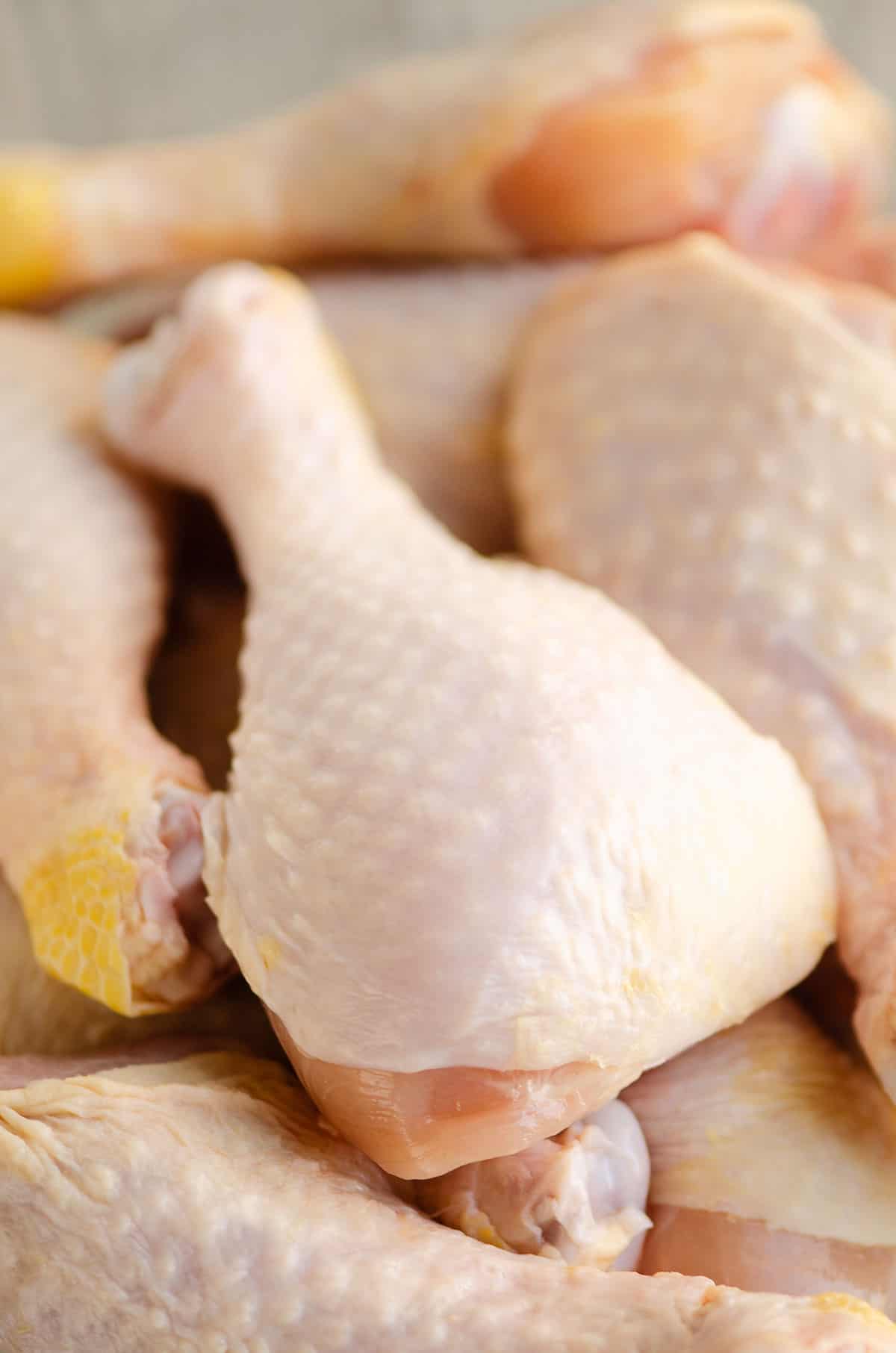 stack of raw chicken drumsticks