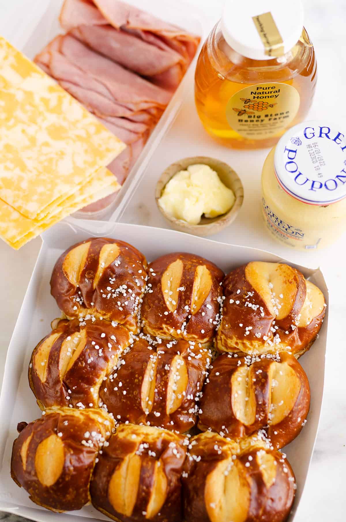 pretzel sliders and ingredients for sliders on table