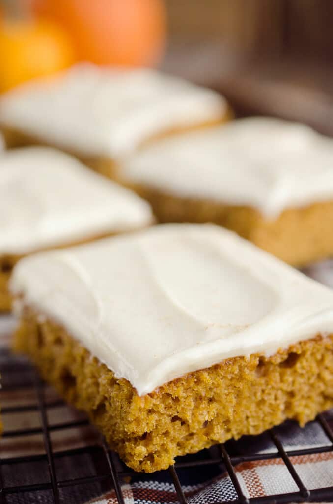 frosted pumpkin cake bars on table