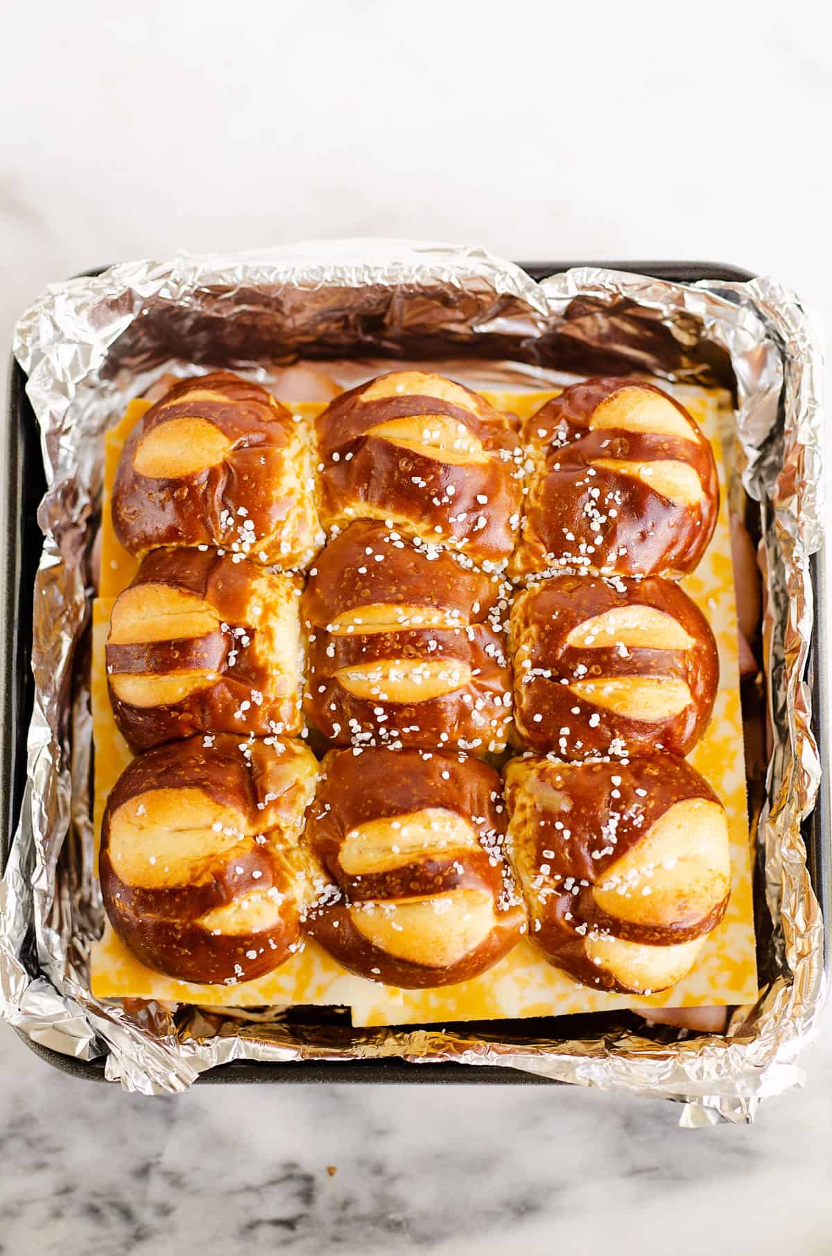 assembled pretzel sliders in pan