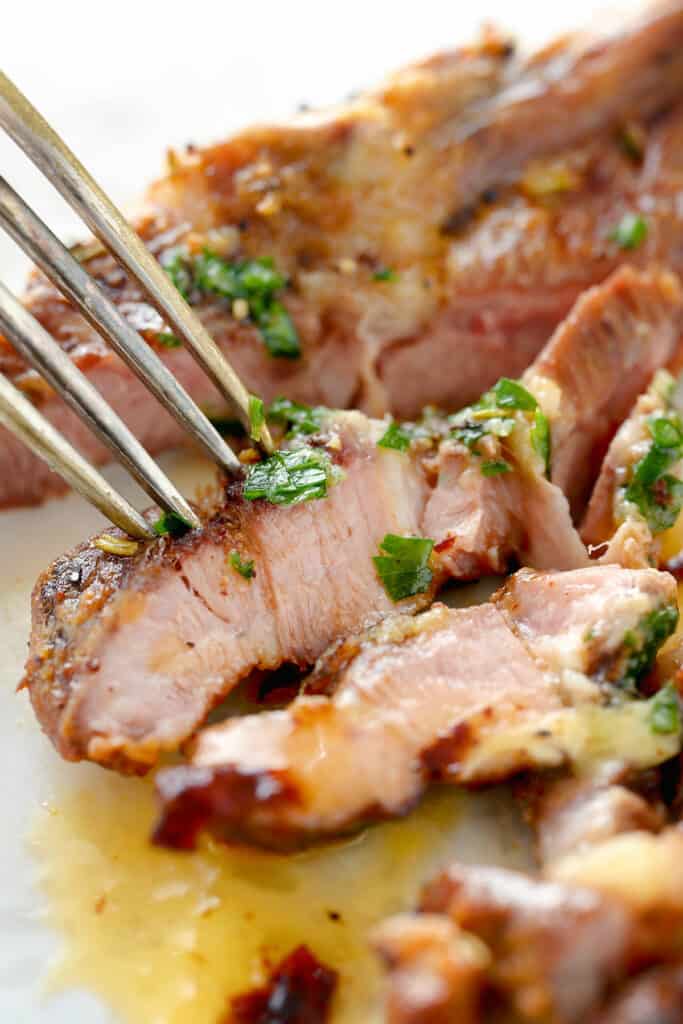 sliced lamb chop on plate with fork