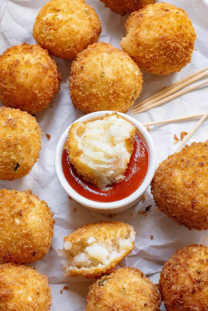 mashed potato ball dunked in ketchup