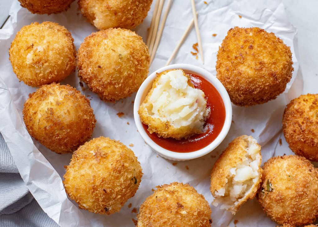 mashed potato ball dipped in ketchup
