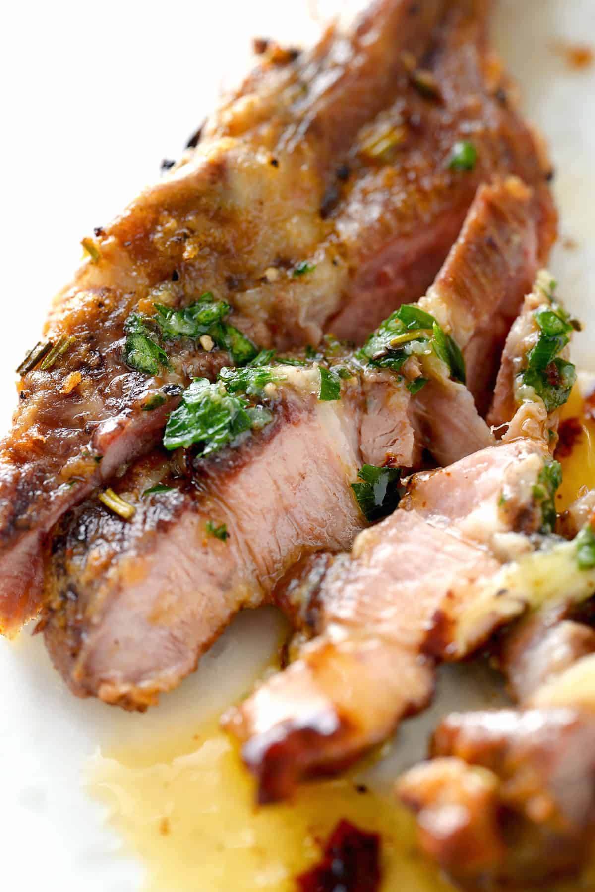 sliced lamb topped with herb butter