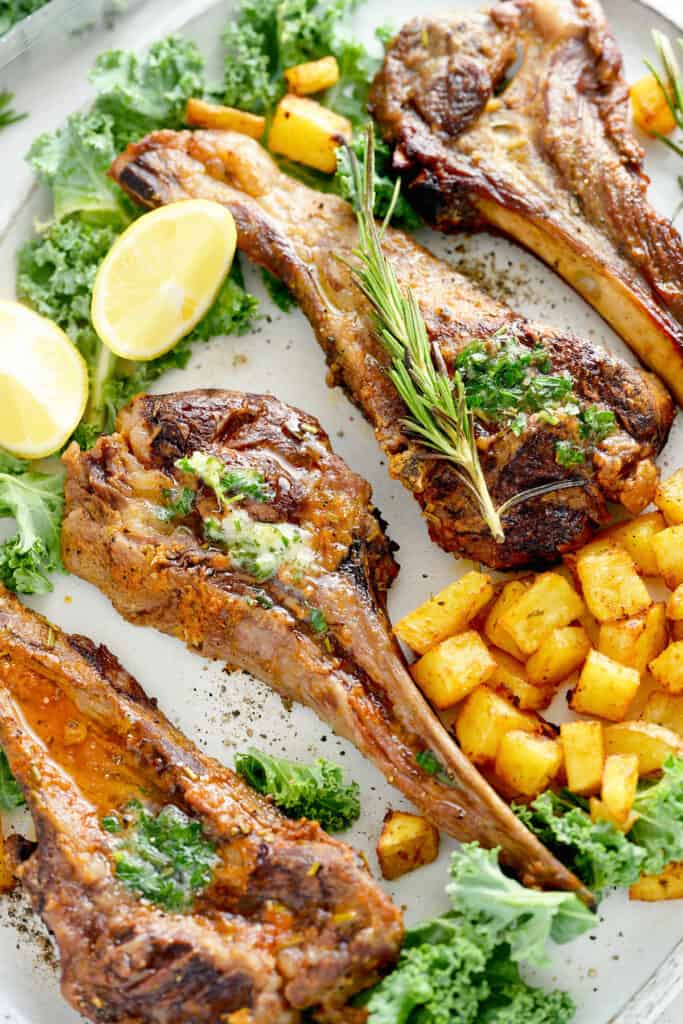 lemon herb marinated lamb on platter with potatoes