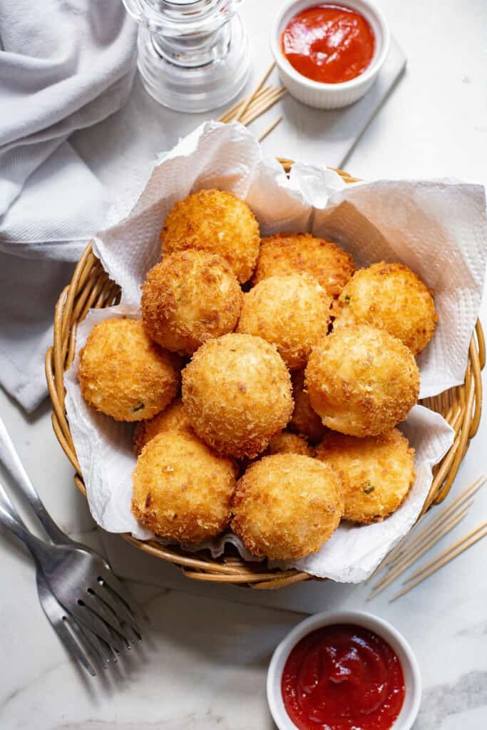 fried mashed potato balls in lined basket