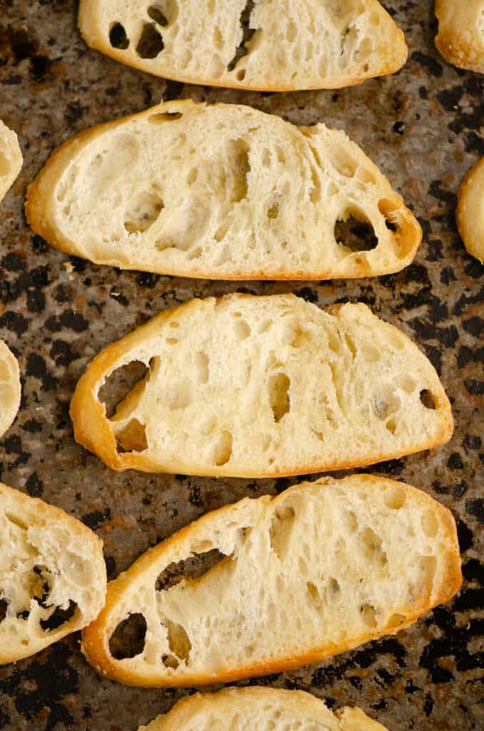 French break slices on baking sheet