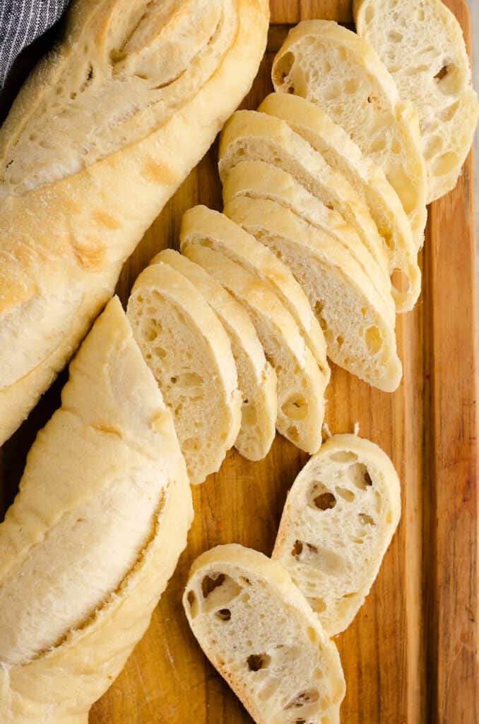 French baguette sliced on cutting board