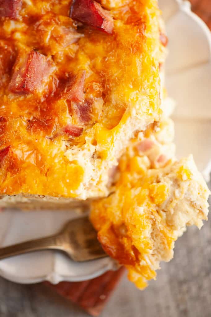 bite of ham and cheese english muffin casserole on plate