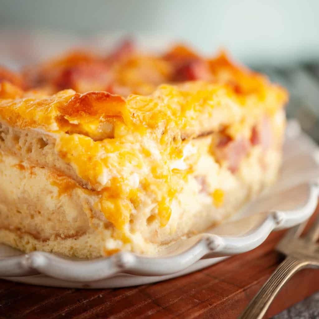 english muffin egg casserole on scalloped plate