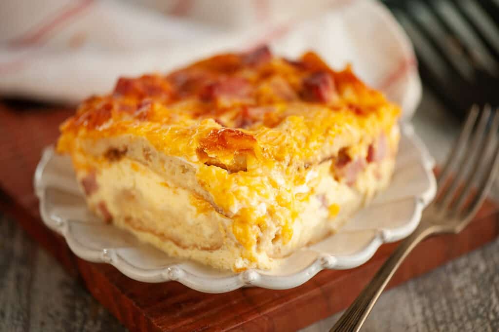 english muffin ham and egg bake on plate with fork