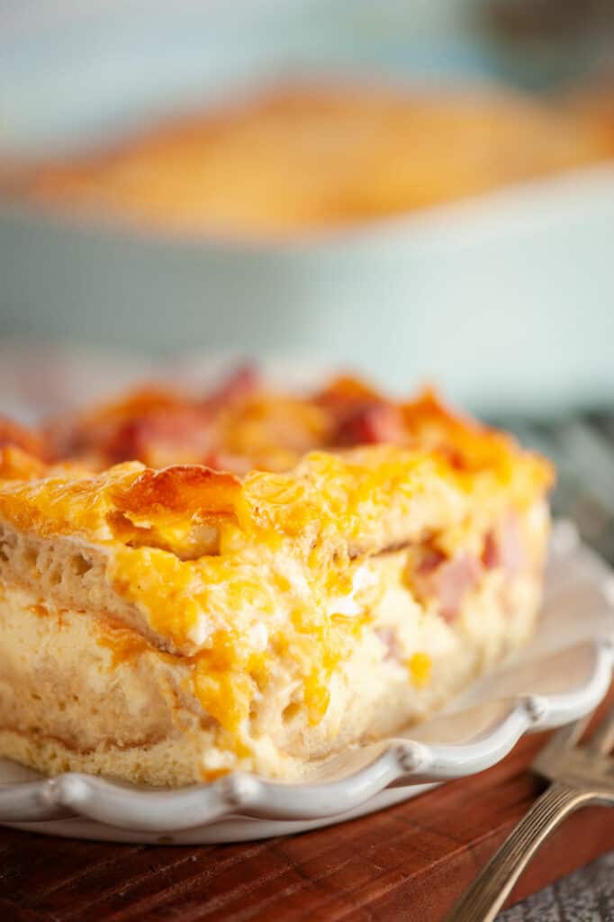 Overnight English Muffin breakfast casserole plated on wood cutting board